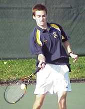 John Oster '03 connects with a service return.