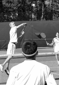 Jeremy Zuidema '02 about to finish a point against Andover while #1 doubles partner Mark Goldberg '03 looks on. [Photo by Mr. Ian Morris.]